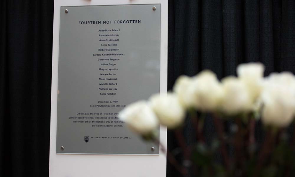 Plaque of remembrance with white roses in front